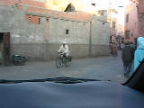 Rachid driving down a narrow street